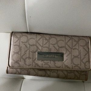 Calvin Klein rose gold wallet , big with lots of compartments